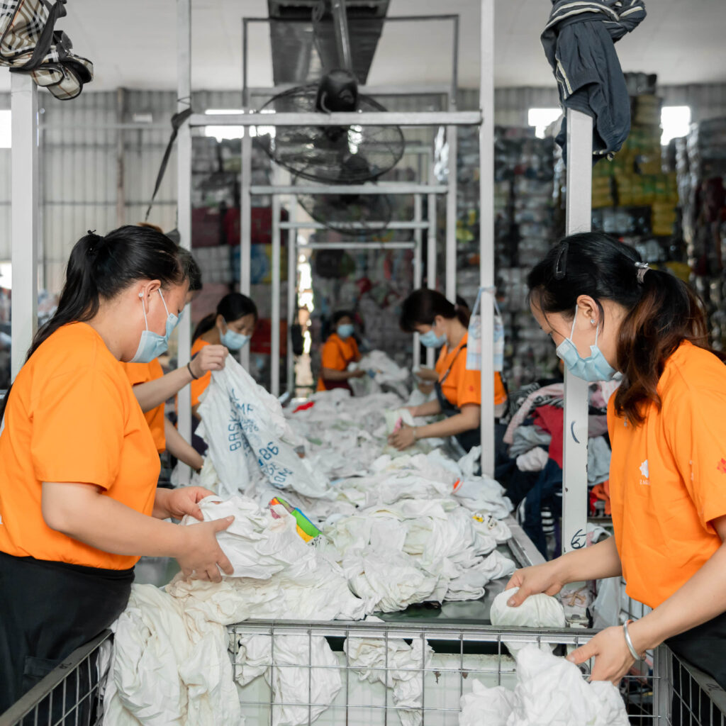 A large selection of used white clothes being screened by our sorting team.