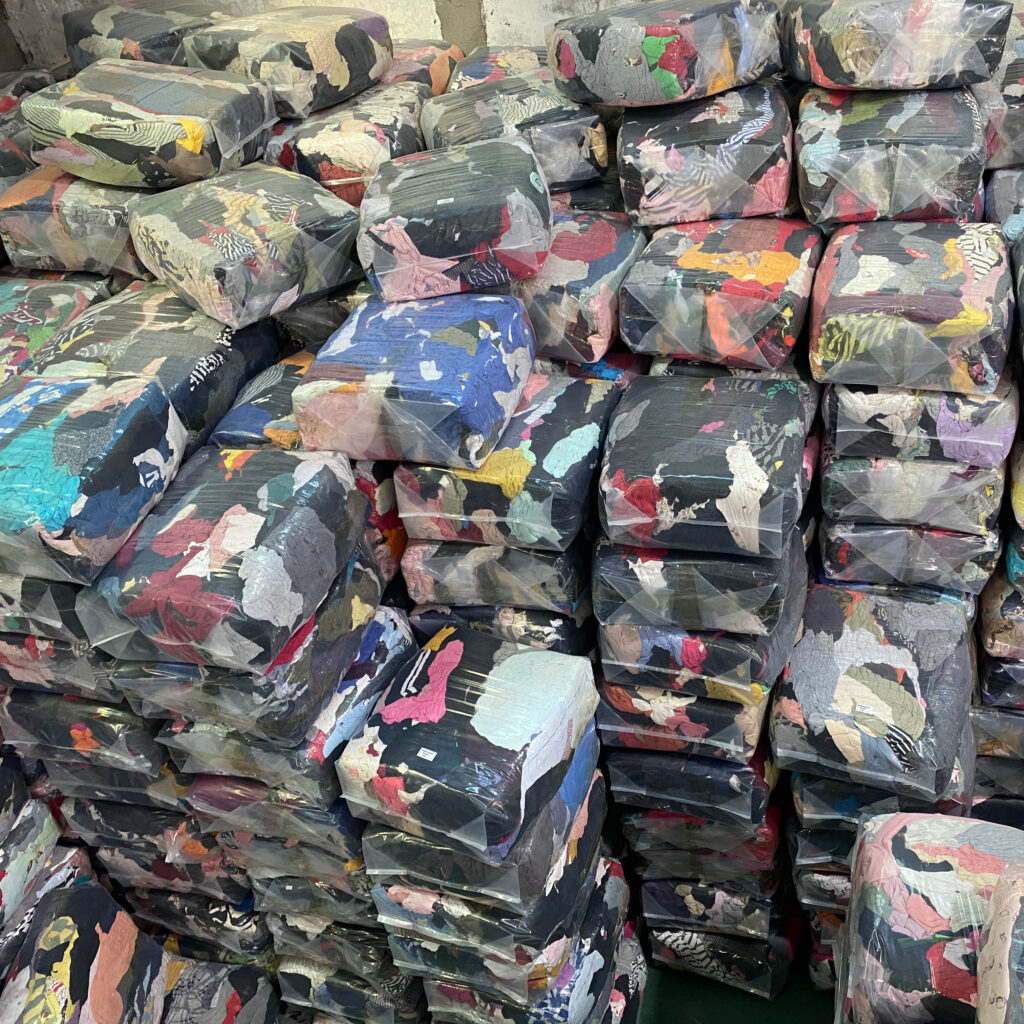 stacks of used clothing securely baled and ready for shipment.