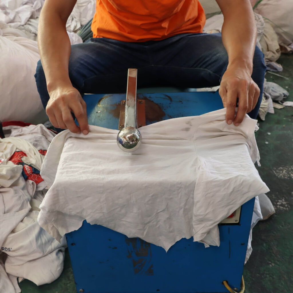 Expert personnel prepares used clothing for mixed rags with keen accuracy.